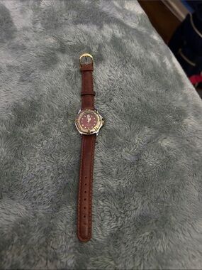 Nike Women's Brown Leather Strap Watch with Burgundy Dial and Gold Accents